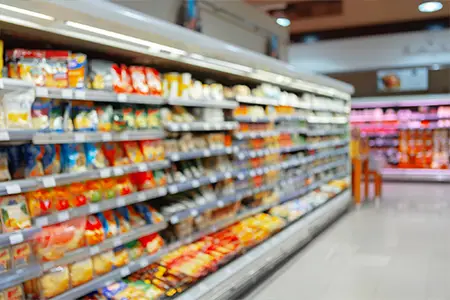Abstract blurred supermarket shelves with products for background